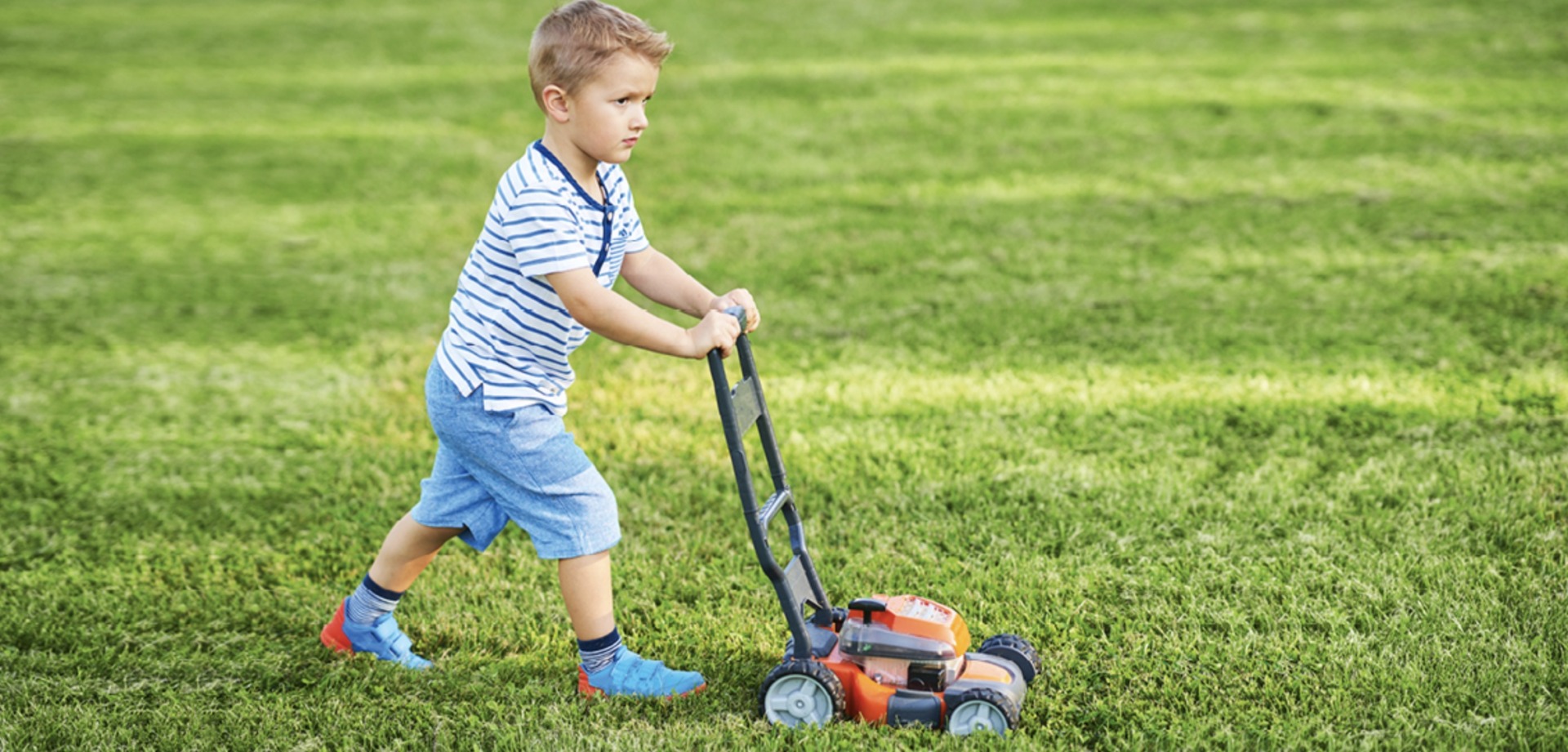 a kid mowing a lawn