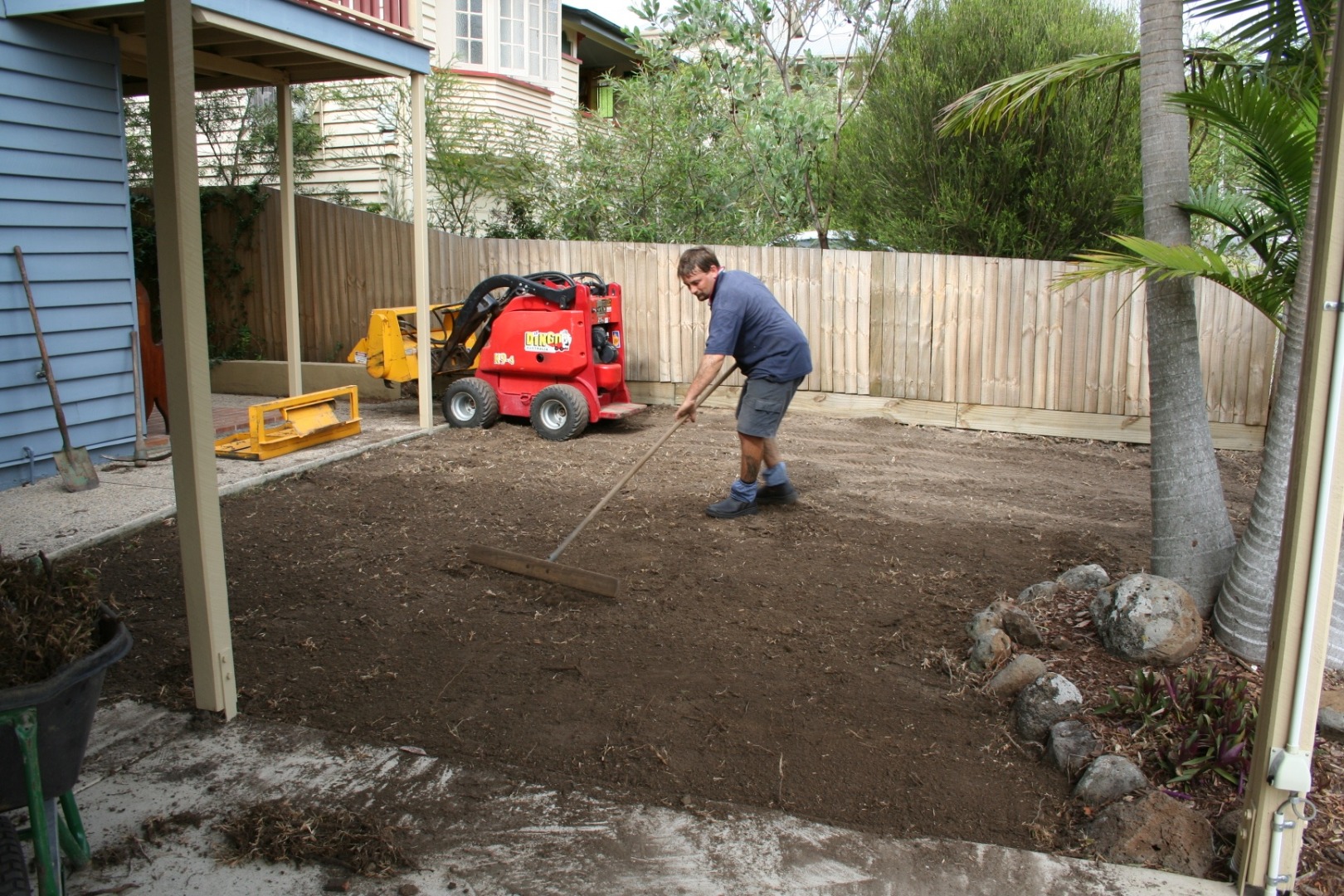 Professional preparing soil for new turf
